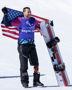 Photo Mike Schulz with American Flag and snowboard.
